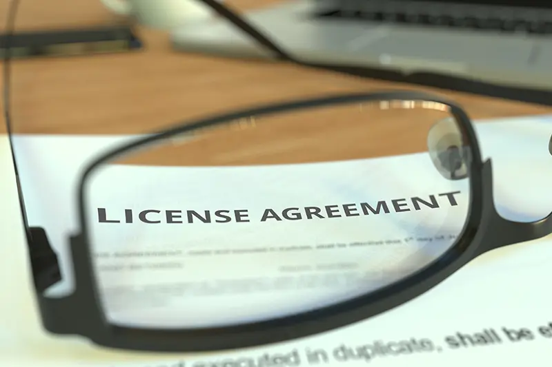 Glasses Laying on top of License Agreement Paperwork Inside of Attorney's Office